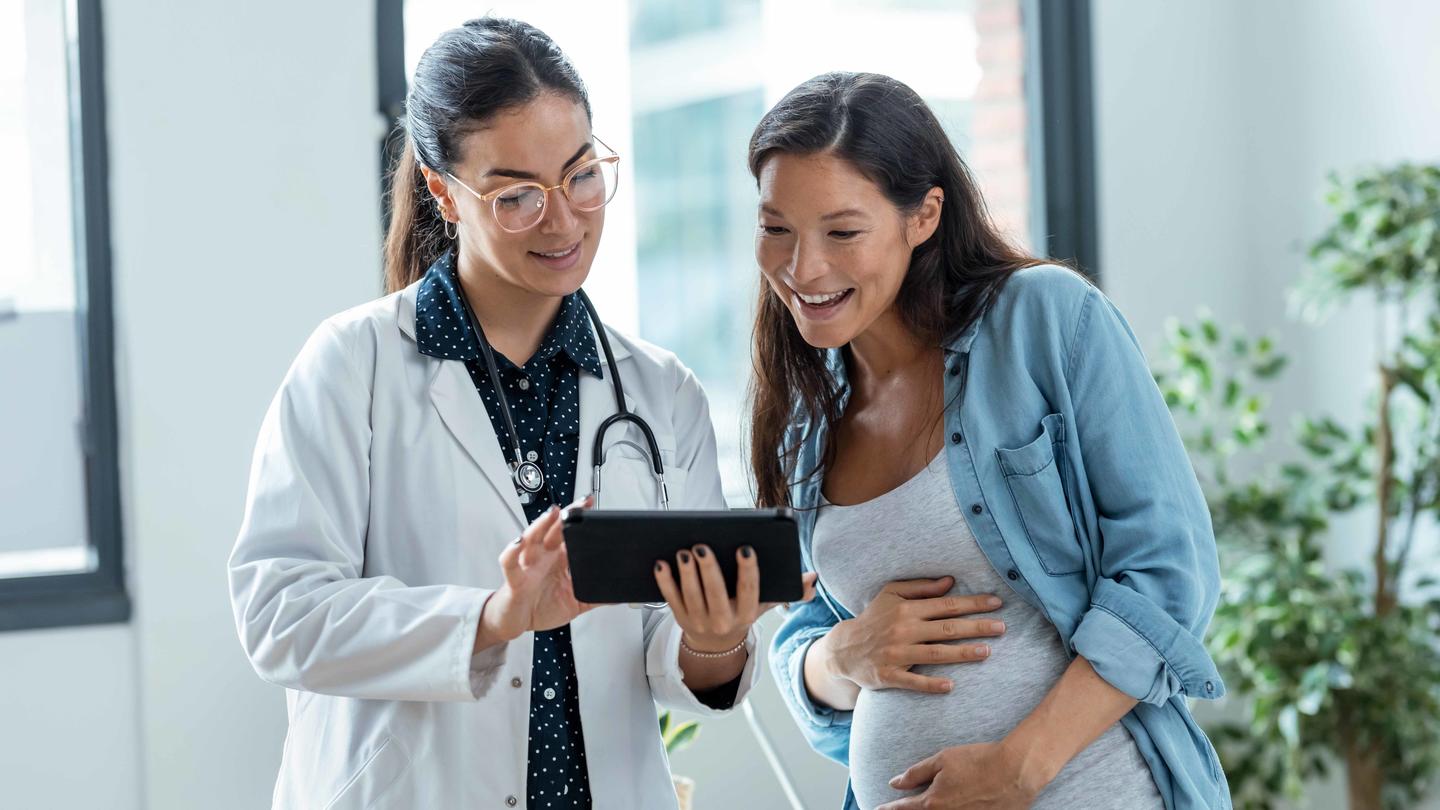 Pregnant woman talking with doctor