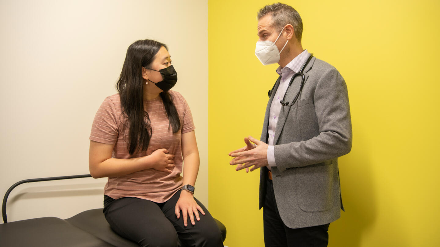Patient with stomach pain consulting a doctor