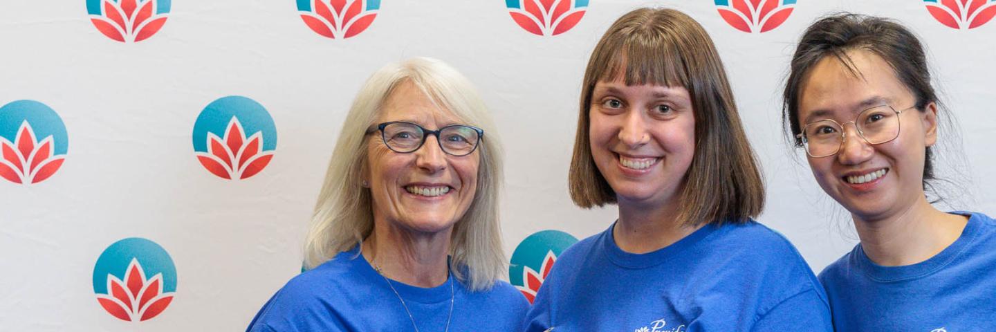 Three volunteers smiling.