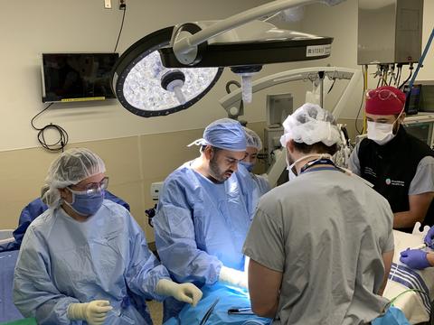 A team of people in scrubs complete a simulation in the operating room