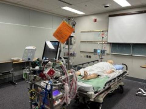A simulation mannequin in a hospital bed