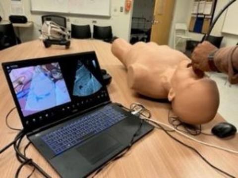 A man uses an ultrasound on a torso mannequin